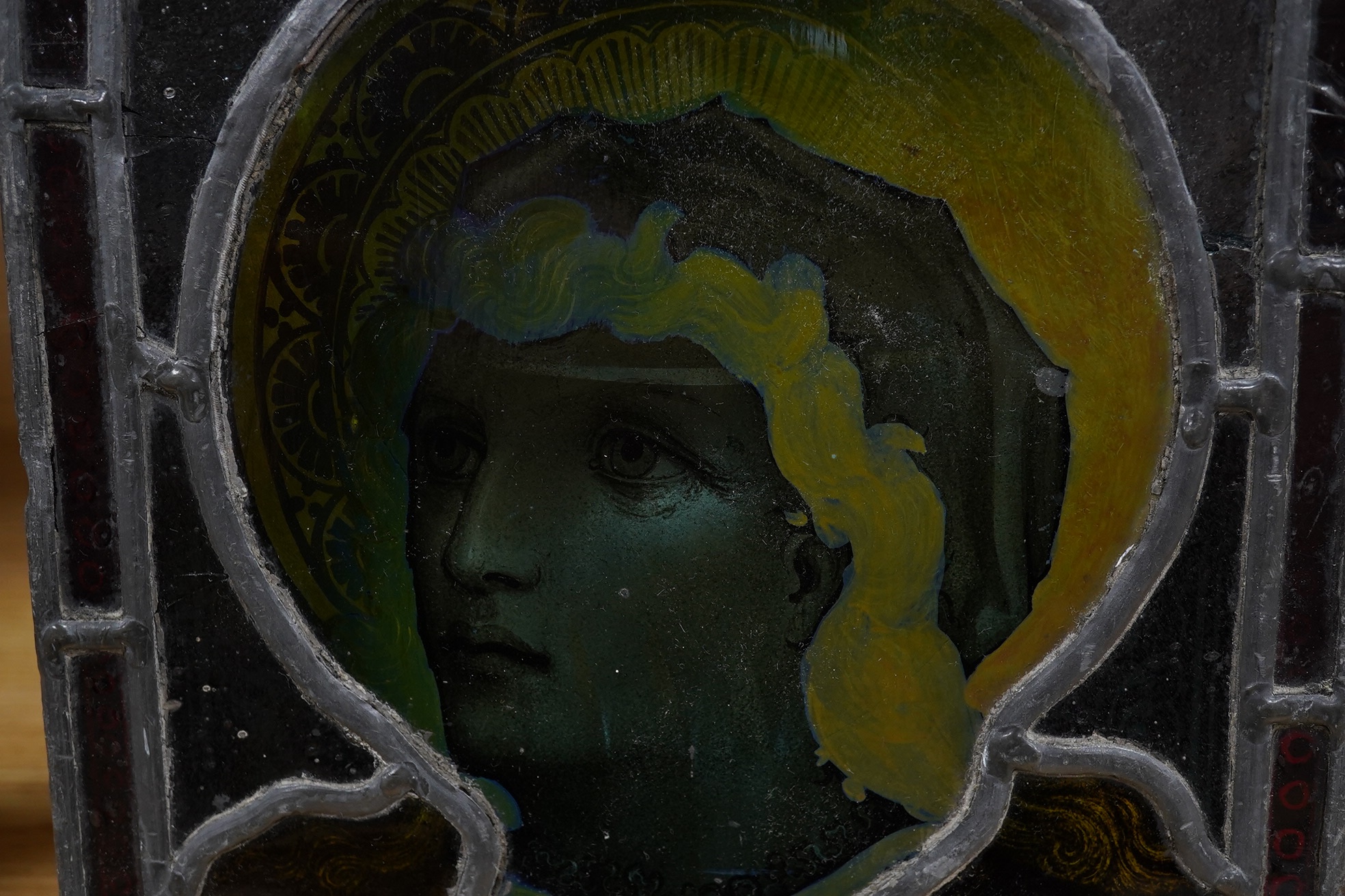 A stained glass panel showing the head of a saint, 21 x 20cm. Condition - four panels cracked